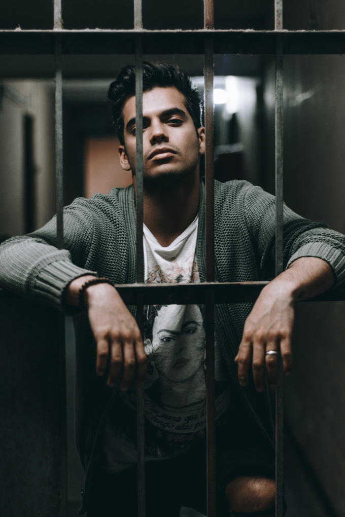 young man behind bars.